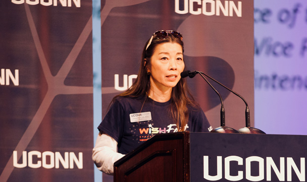 UConn Waterbury director Fumiko Hoeft speaks from the stage