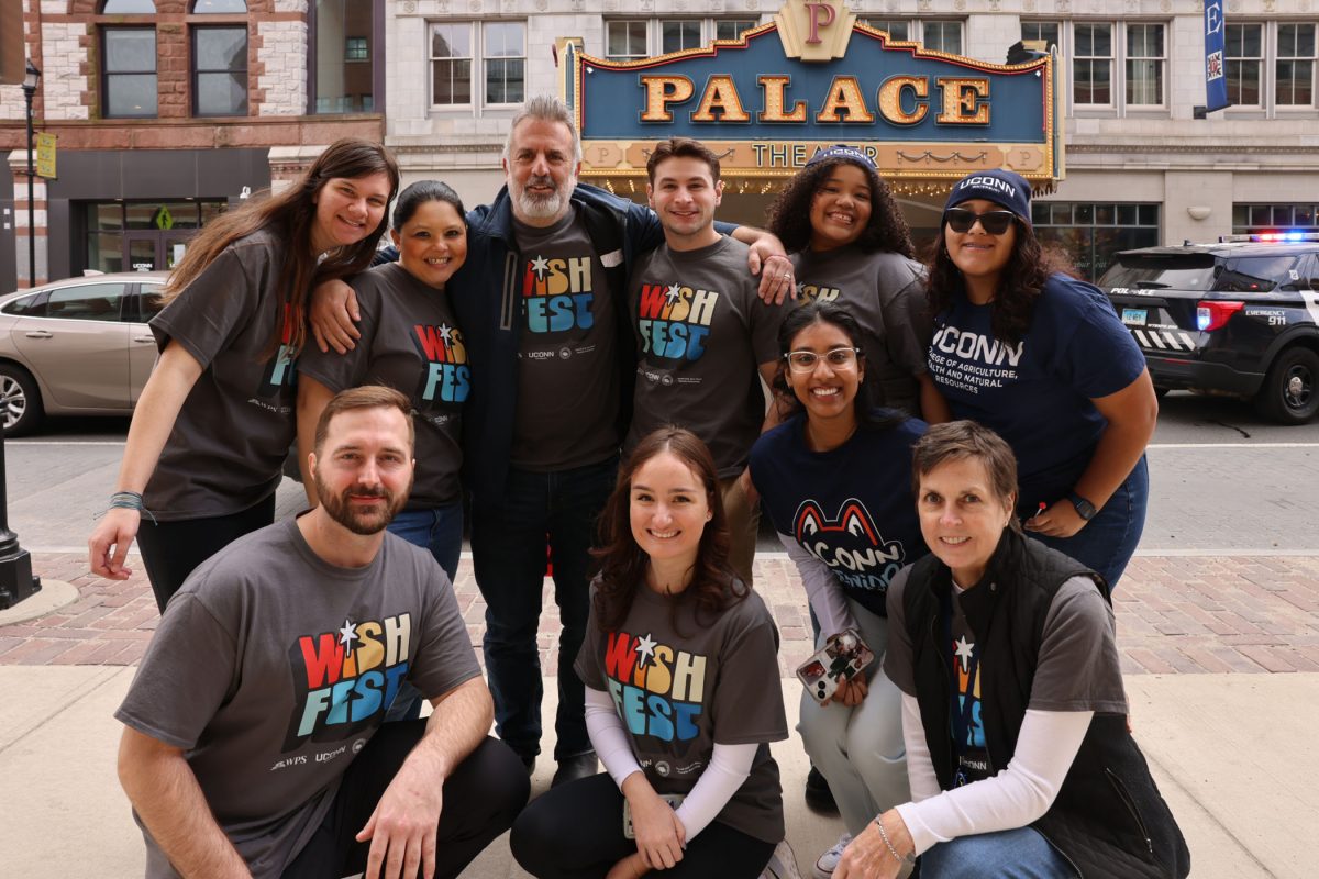 A group of WISHfest staff pose in front of the Palace Theater